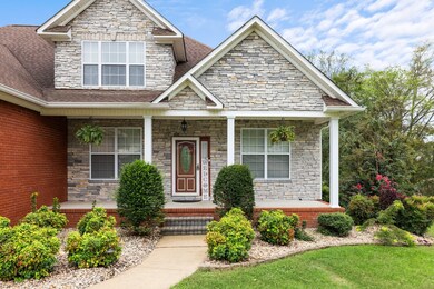 Enjoy coffee on your front porch surrounded by beautiful landscaping.