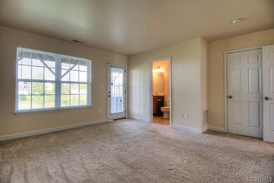Bedroom 2 on the 1st level with wall to wall carpet, closet and private bath