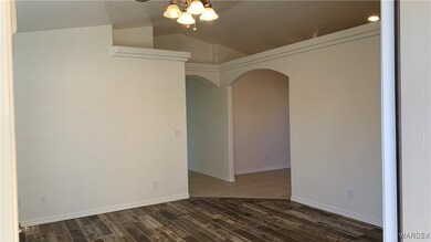 Spare room with a textured ceiling, dark wood-type