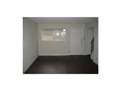 Spare room with dark wood-style floors, stairway,