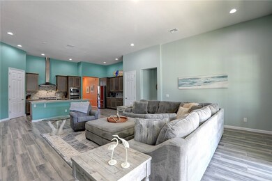 Living room with recessed lighting and light wood-style floors