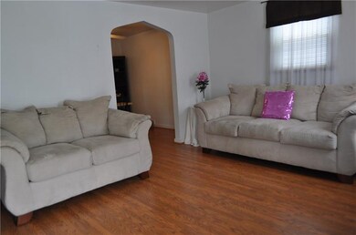Spacious living room with laminate flooring.