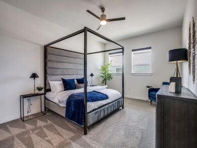 Bedroom featuring ceiling fan and carpet flooring