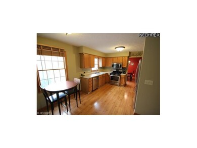 Eat-in kitchen with stainless steel appliances.