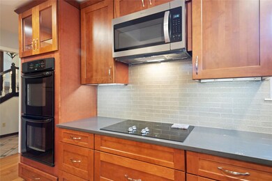 Kitchen with tasteful backsplash, double oven and 