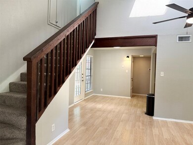 Stairway with wood finished floors and a ceiling 
