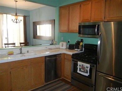 Kitchen features stainless steel appliances, oak c