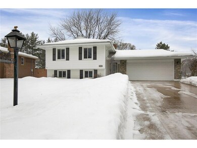 Concrete driveway leading to 2 car garage