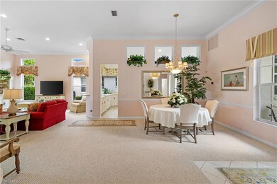 Dining area with plenty of natural light, light colored carpet, crown molding, a chandelier, and recessed lighting