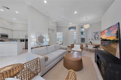 Living room with ceiling fan, light tile patterned