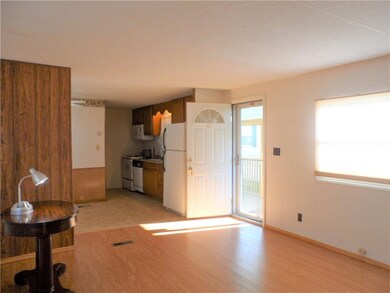 Living room looking toward kitchen and entrance