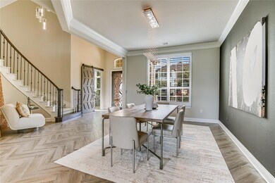 Dining space with stairway and ornamental molding