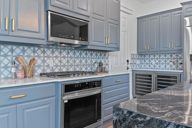 Kitchen with decorative backsplash, stainless ste