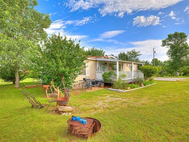 View of green lawn with covered porch