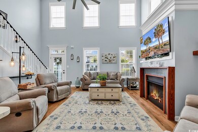 Living room featuring a towering ceiling, light ha