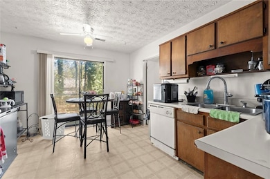 Kitchen featuring brown cabinets, light floors, op