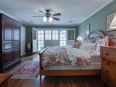 Spacious master bedroom has handsome plantation sh