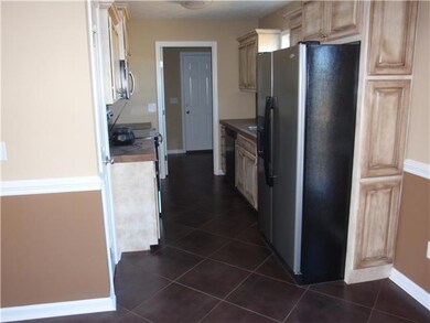Kitchen has stainless appliances with Dishwasher, Refrigerator, Stove