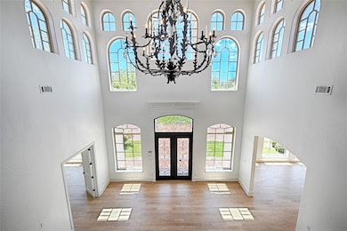 Foyer with a high ceiling, a healthy amount of sun