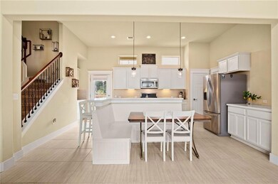 Dining area with stairs and recessed lighting