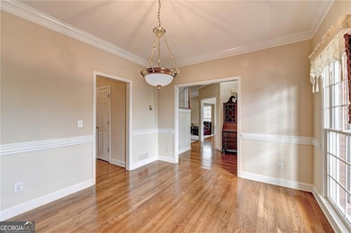 Unfurnished formal dining room with light wood fin