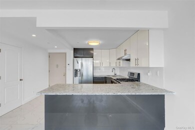 Kitchen featuring tasteful backsplash, stainless steel appliances, light stone counters, a peninsula, and recessed lighting