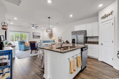 Kitchen with ceiling fan, stainless steel applianc
