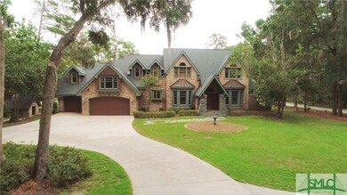 Front of Estate with winding drive and lots of ope
