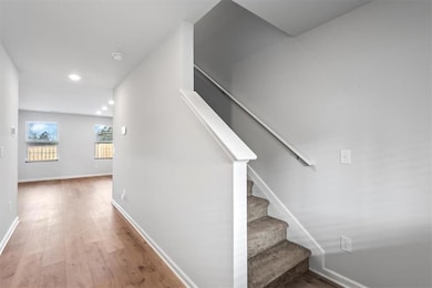 Stairs featuring recessed lighting, baseboards, an