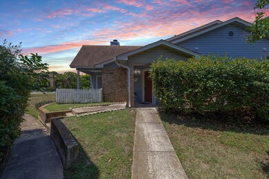 View of front of house with a shingled roof, bric