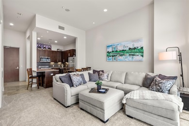 Living area with visible vents, recessed lighting,