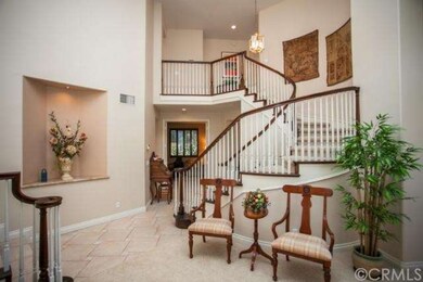 DRAMATIC FORMAL ENTRY WITH ROUNDED STAIRWAY & SOAR