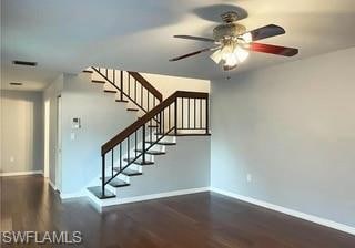 Stairway featuring wood-style finished floors and a ceiling fan