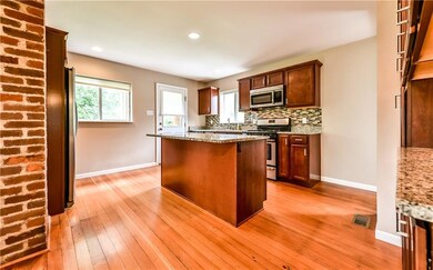 Large center island with granite counter tops.