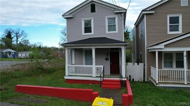 View of property with a porch and a front yard