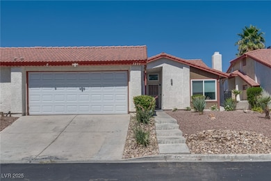Single story home with stucco siding, driveway, a