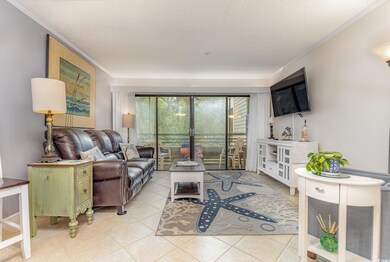 Tiled living room featuring ornamental molding and