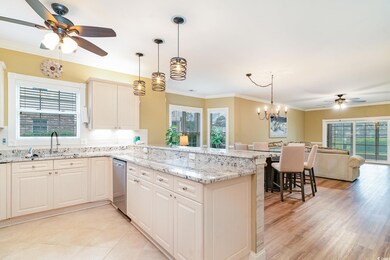 Kitchen featuring ceiling fan with notable chandel
