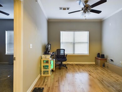 Home office with ceiling fan, crown molding, base