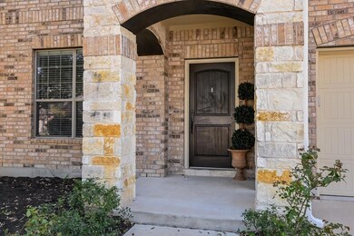 Doorway to property featuring stone siding and br