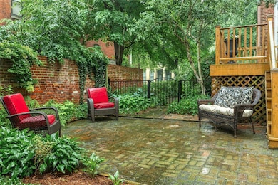 Brick patio plus new iron fencing presents a relax