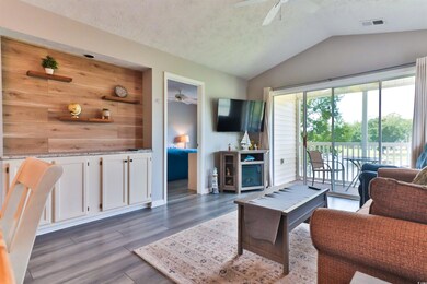 Living room featuring lofted ceiling, ceiling fan,