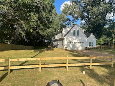 View of front of home with driveway and an attached garage