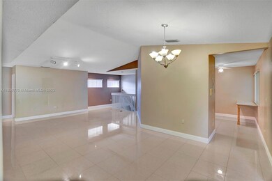 To right is kitchen, to left are stairs to front door