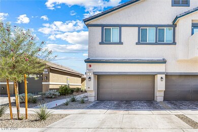 View of front facade with stucco siding, decorative driveway, and an attached garage