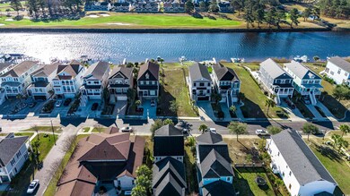 Birds eye view of property with a water view and a residential view