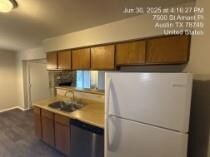 Kitchen with freestanding refrigerator, dishwashe
