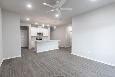 Kitchen with white cabinets, pendant lighting, dar