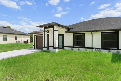 Back of property featuring a garage, stucco siding