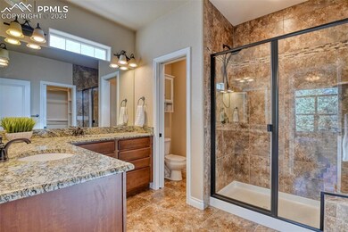 Bathroom with a shower with door, vanity, toilet, 